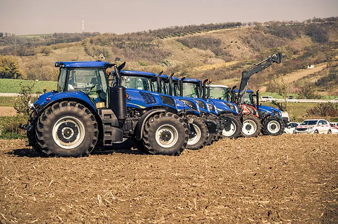 Row of tractors in a field